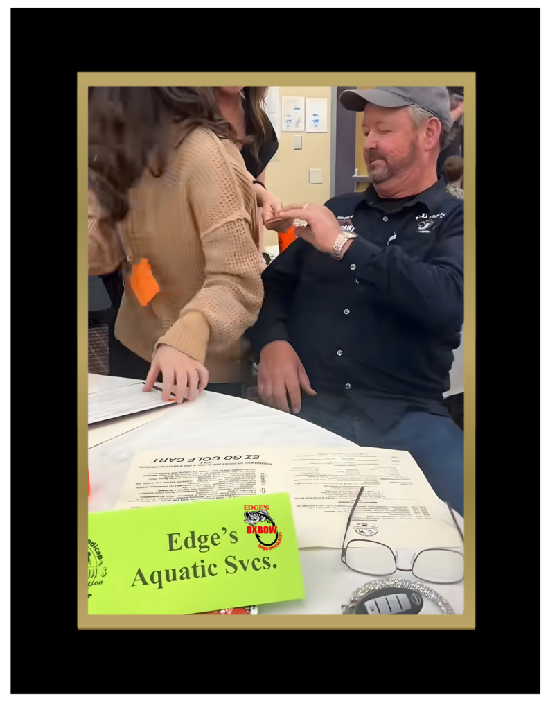 Keith Edge sitting at a bidding table at the 2026 Sportsman Club's annual disability banquet supporting community