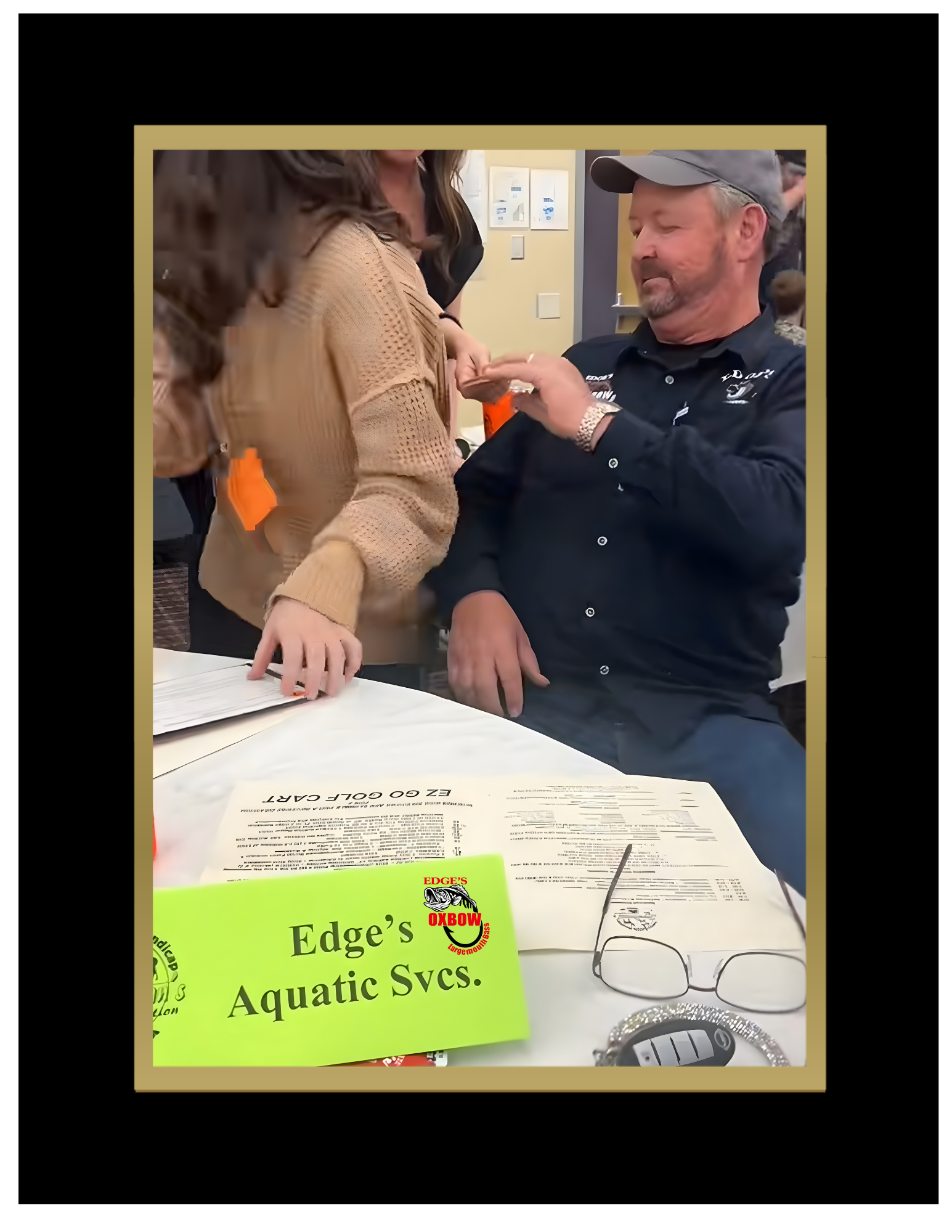 Keith Edge sitting at a bidding table at the 2026 Sportsman Club's annual disability banquet supporting community